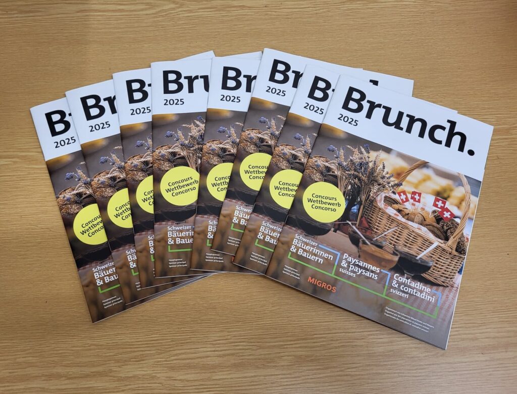 Many brunch magazines on a wooden table.